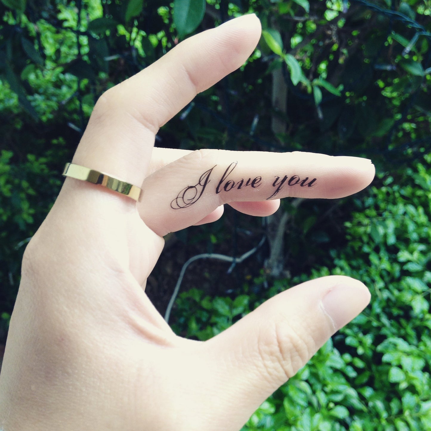 fake small i love you lettering temporary tattoo sticker design idea on finger