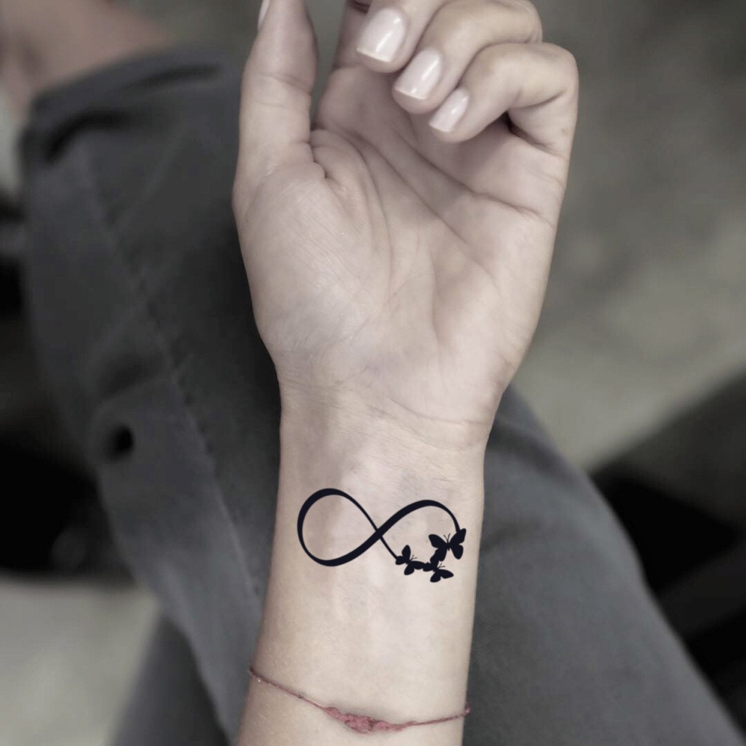 fake small infinity butterfly minimalist temporary tattoo sticker design idea on wrist