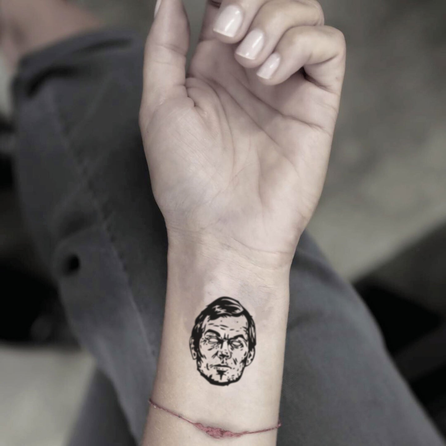fake small jeffrey dahmer portrait temporary tattoo sticker design idea on wrist