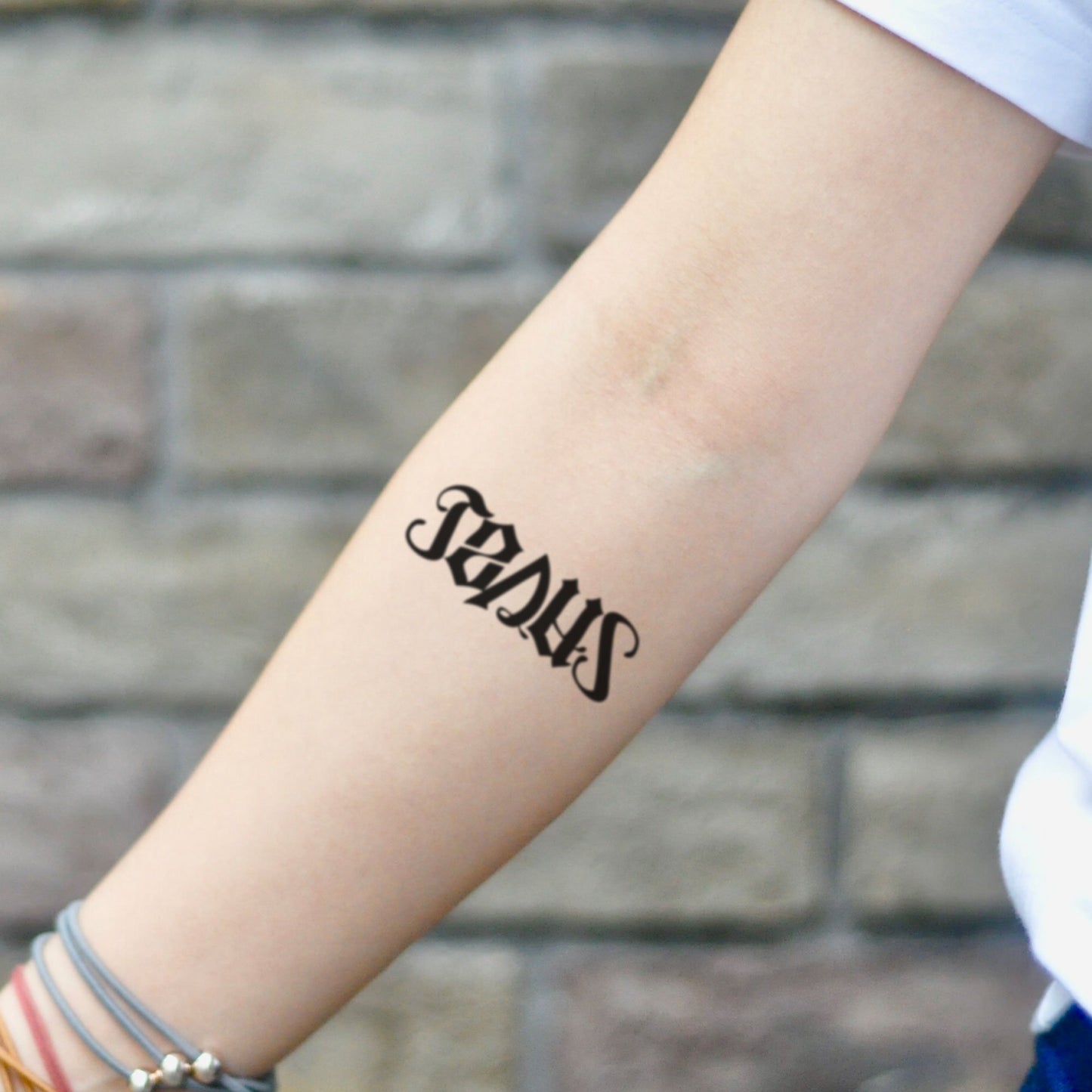 fake small jesus saves ambigram lettering temporary tattoo sticker design idea on inner arm