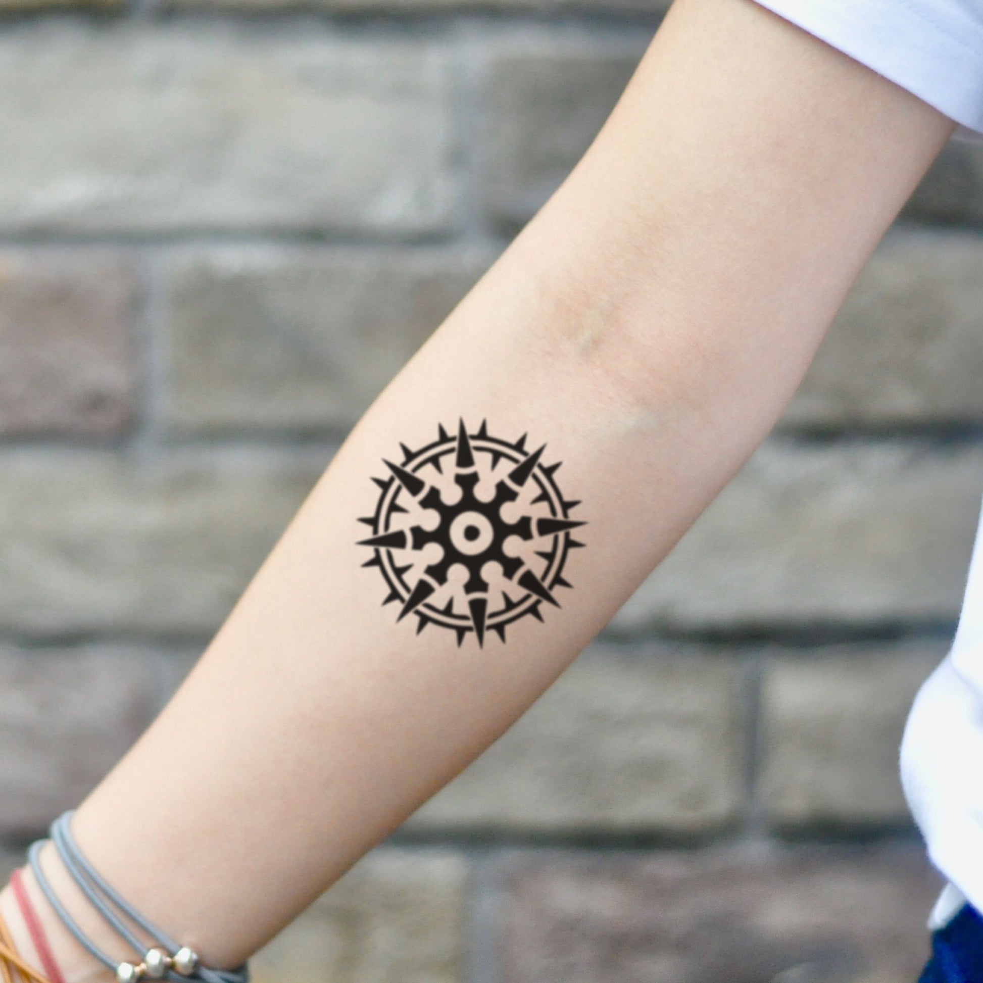 fake small juggernaut wheel geometric temporary tattoo sticker design idea on inner arm