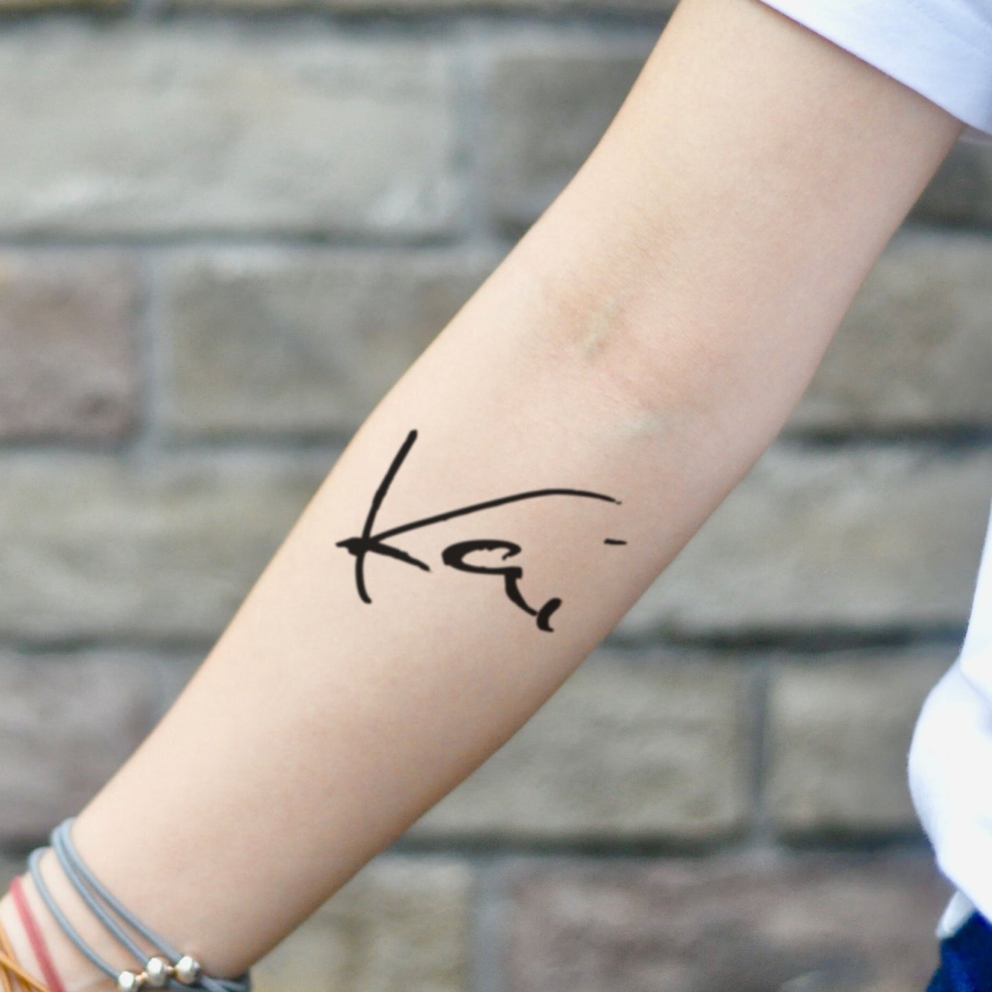 fake small kai name lettering temporary tattoo sticker design idea on inner arm