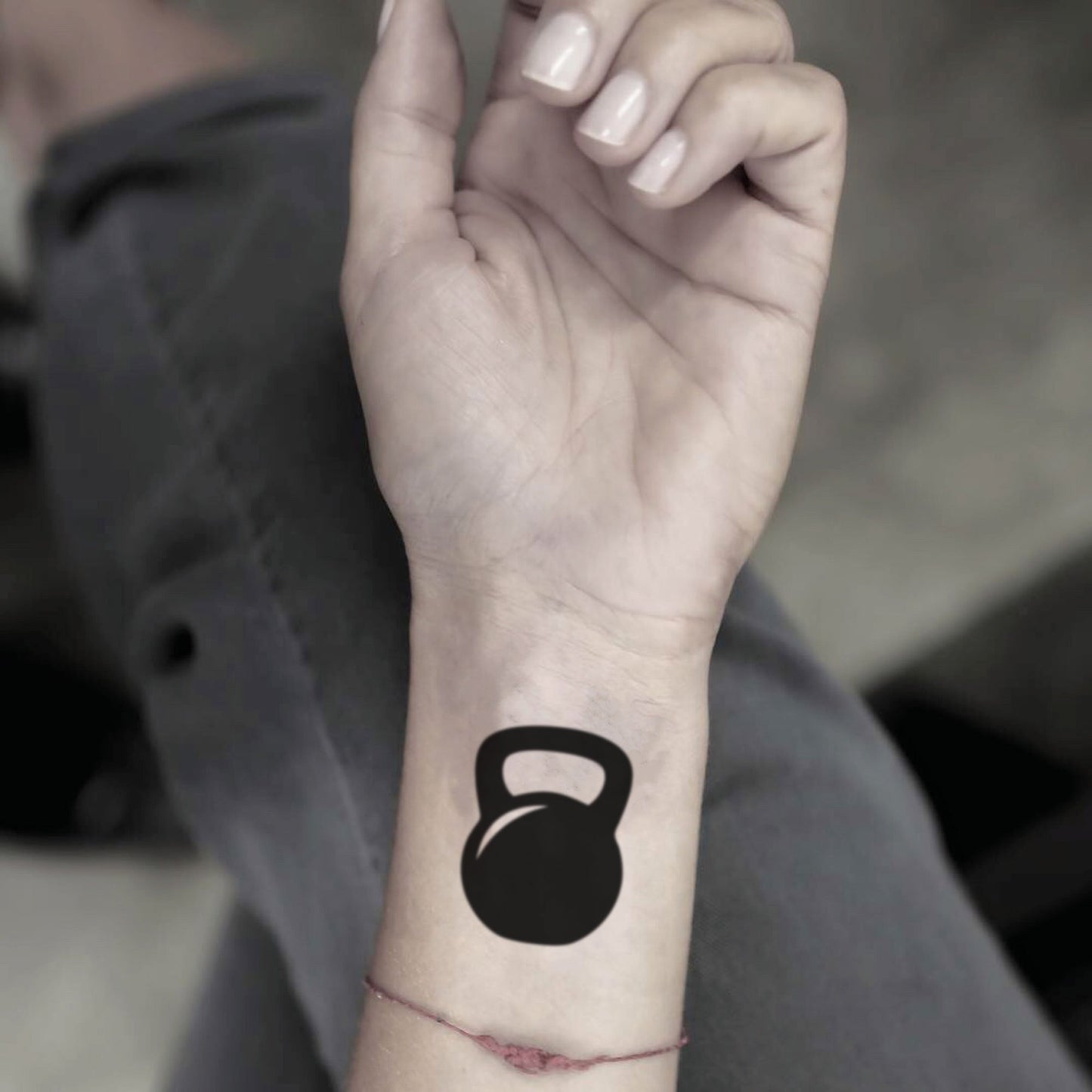 fake small kettlebell minimalist temporary tattoo sticker design idea on wrist
