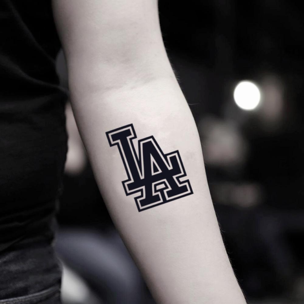 fake small la dodgers lettering temporary tattoo sticker design idea on inner arm