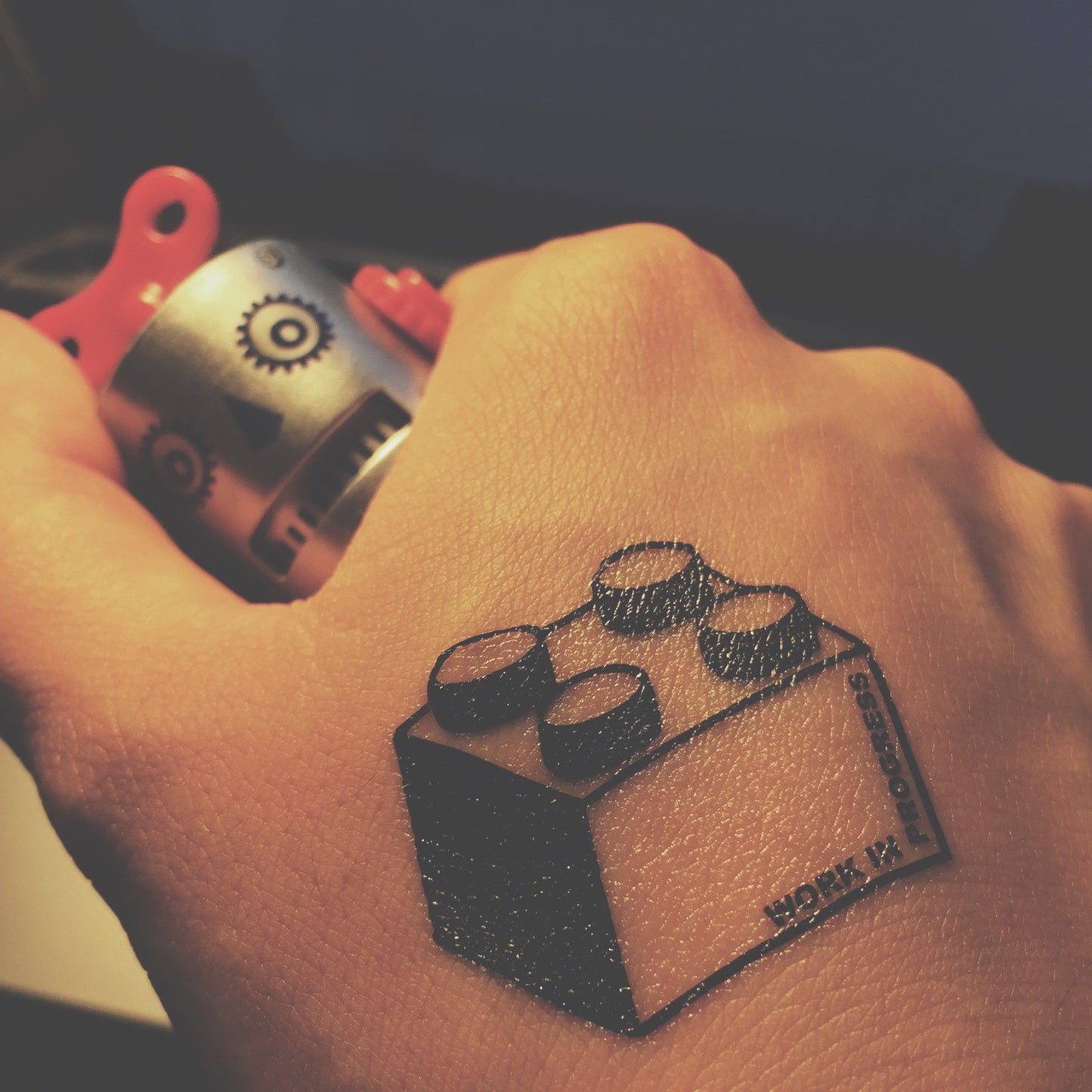 fake small lego block illustrative temporary tattoo sticker design idea on wrist