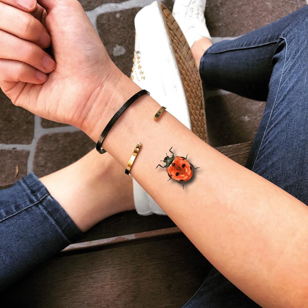 fake small ladybug love bug animal color temporary tattoo sticker design idea on wrist