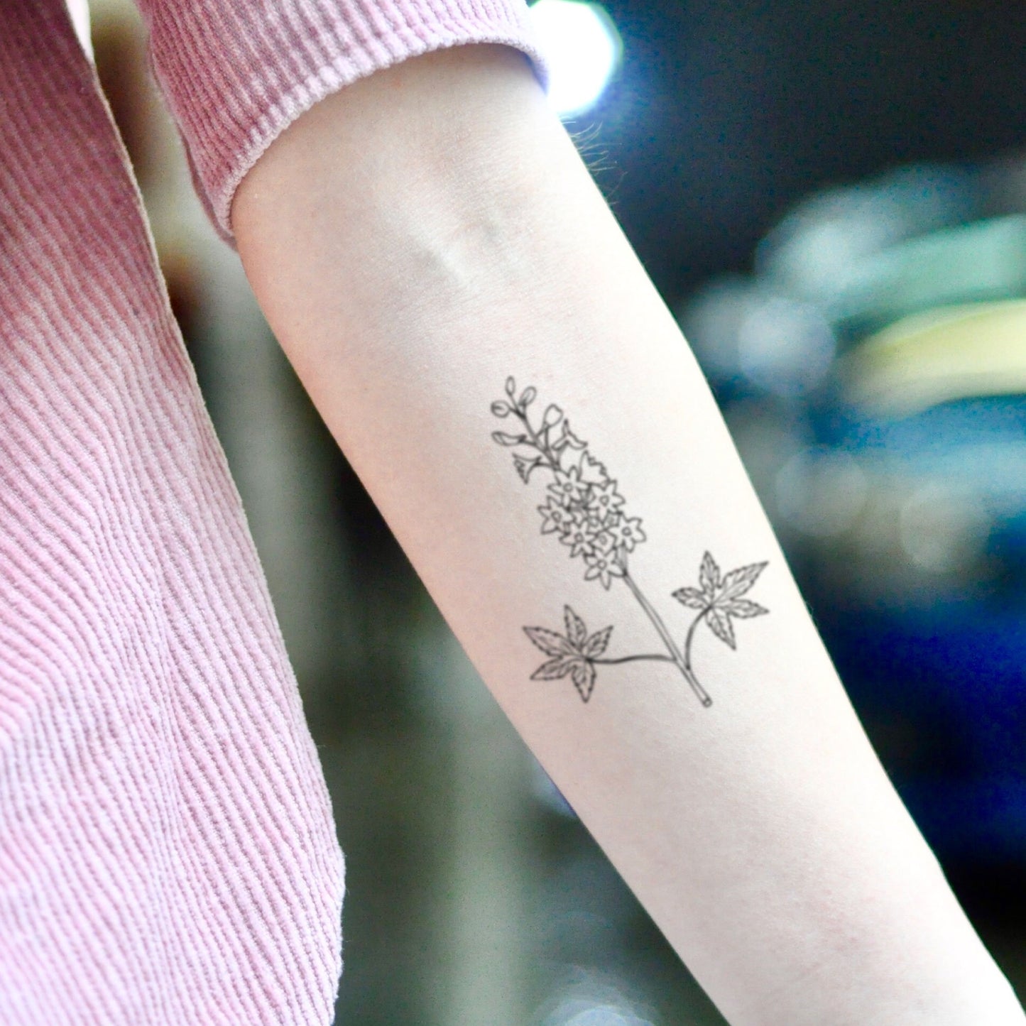 fake small larkspur flower temporary tattoo sticker design idea on inner arm