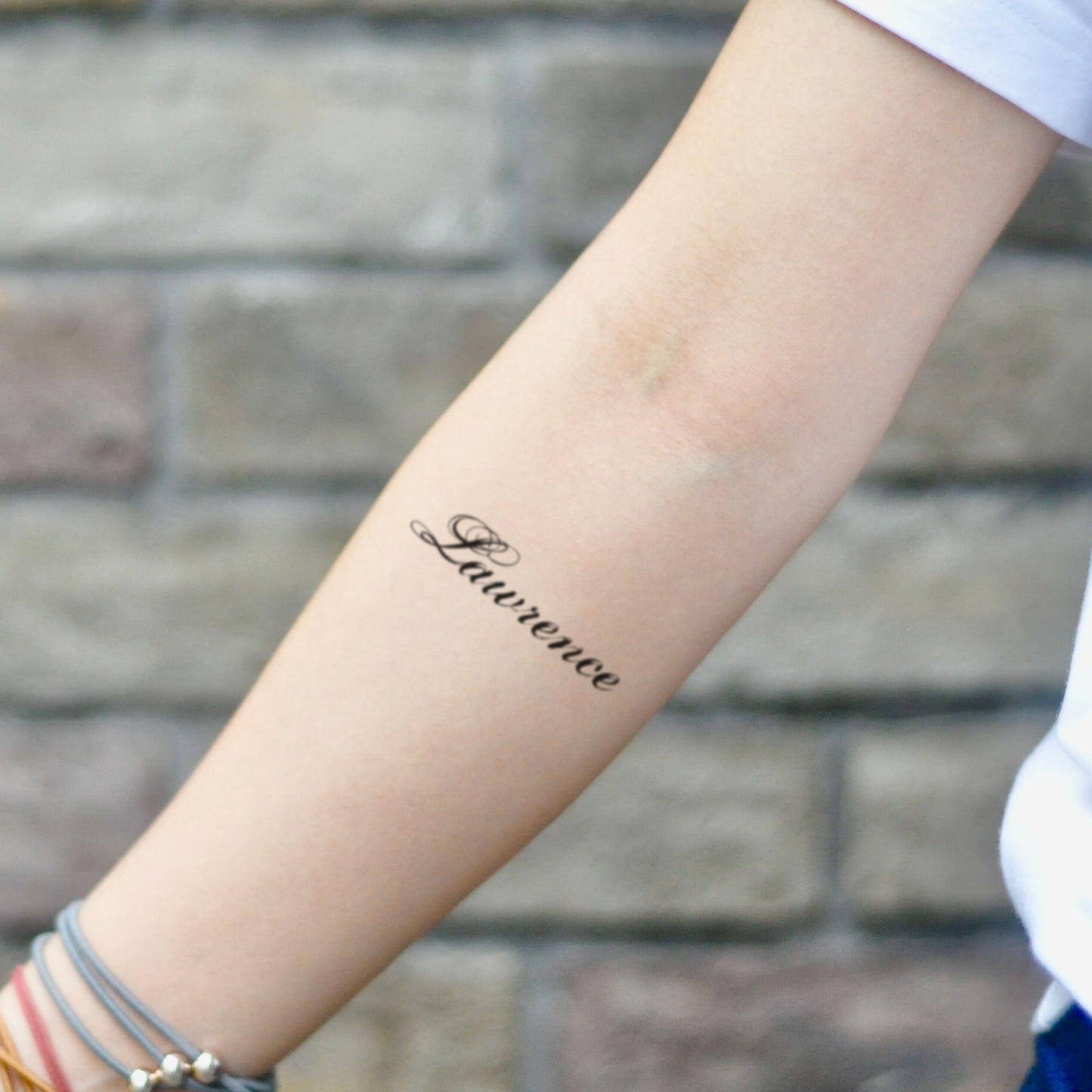 fake small lawrence name lettering temporary tattoo sticker design idea on inner arm
