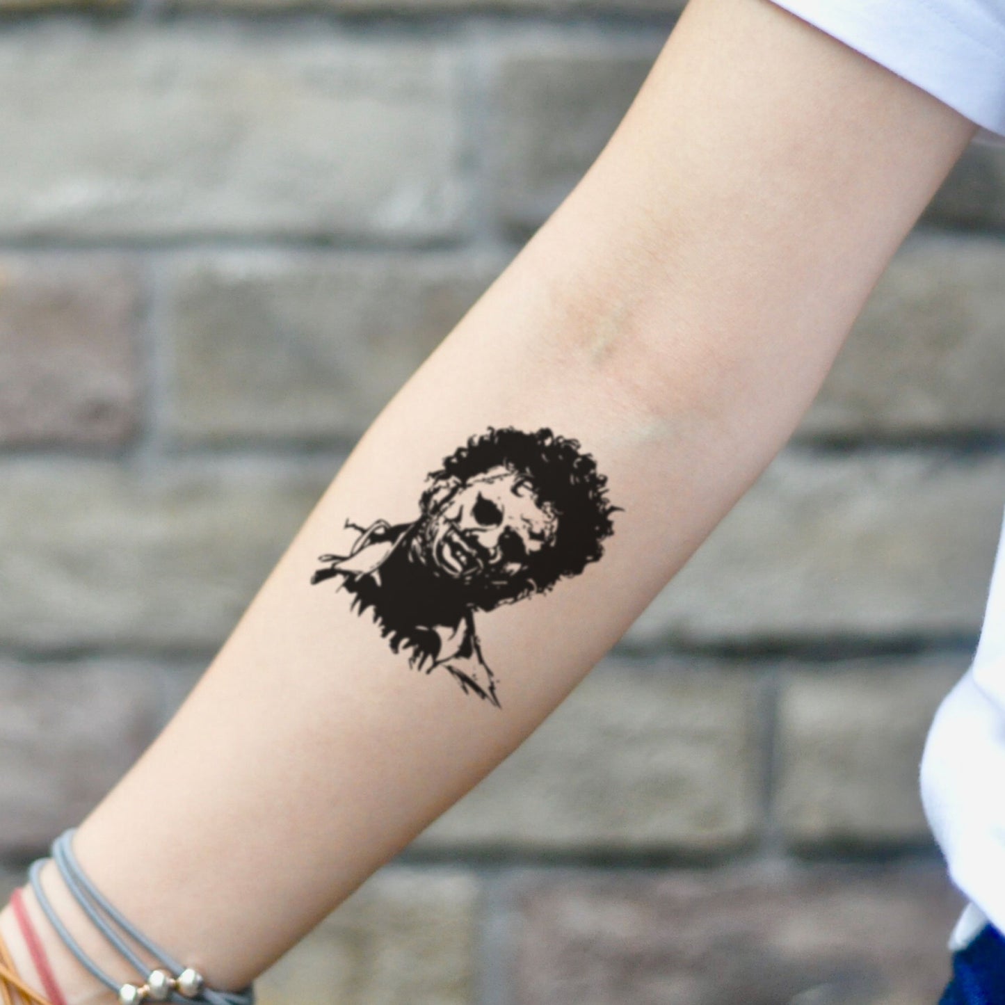 fake small leatherface portrait temporary tattoo sticker design idea on inner arm