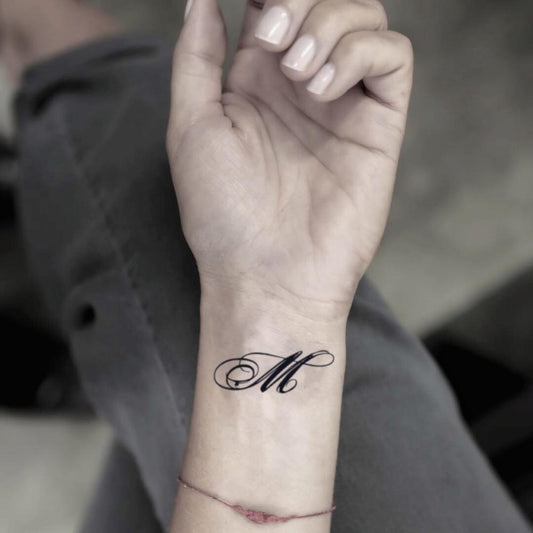 fake small letter m lettering temporary tattoo sticker design idea on wrist