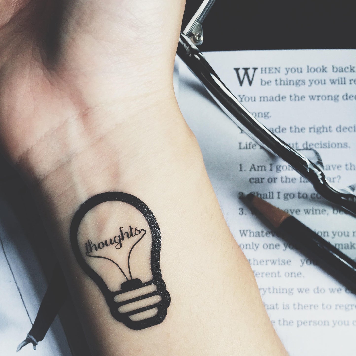 fake small light bulb lightbulb illustrative temporary tattoo sticker design idea on wrist