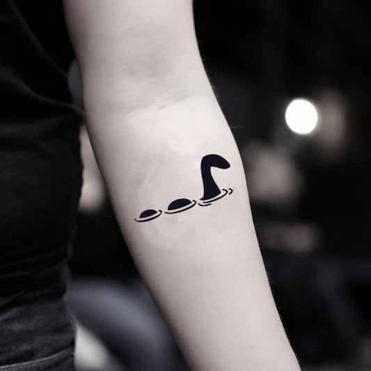 fake small loch ness monster animal temporary tattoo sticker design idea on inner arm