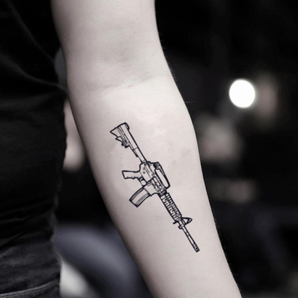 fake small m4 carbine tommy gun ak-47 illustrative temporary tattoo sticker design idea on inner arm