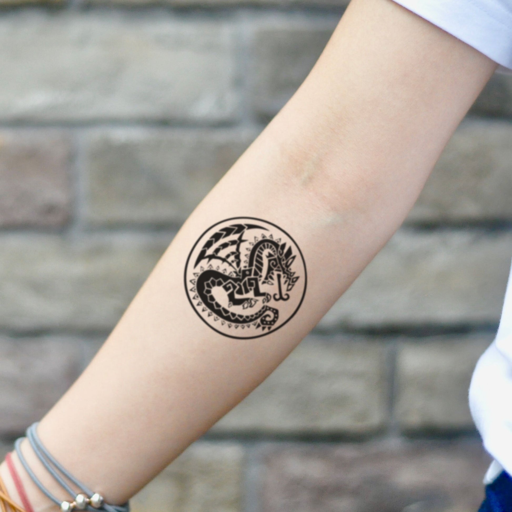 fake small monster hunter illustrative temporary tattoo sticker design idea on inner arm