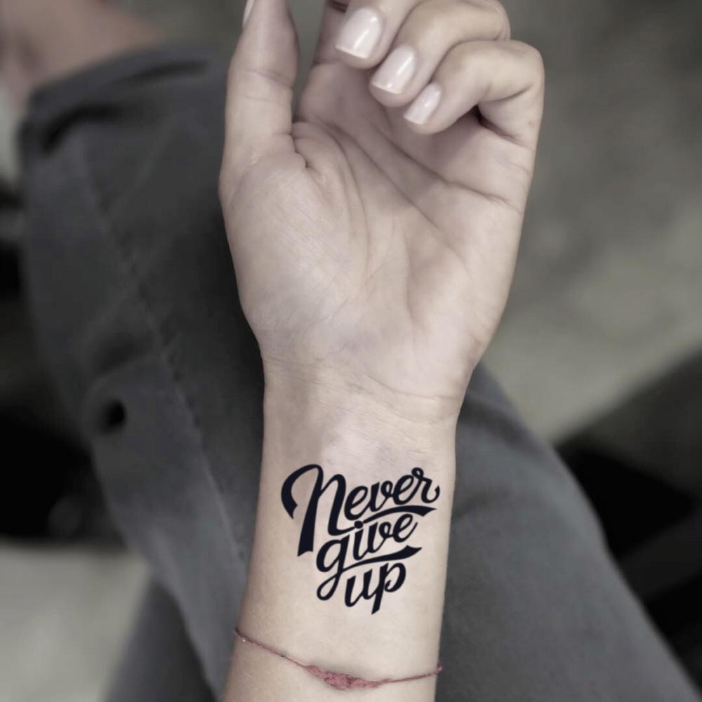 fake small never give up lettering temporary tattoo sticker design idea on wrist
