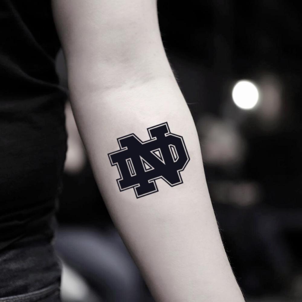 fake small notre dame lettering temporary tattoo sticker design idea on inner arm