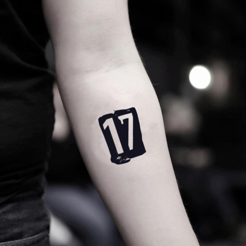 fake small number 17 numeral lettering temporary tattoo sticker design idea on inner arm