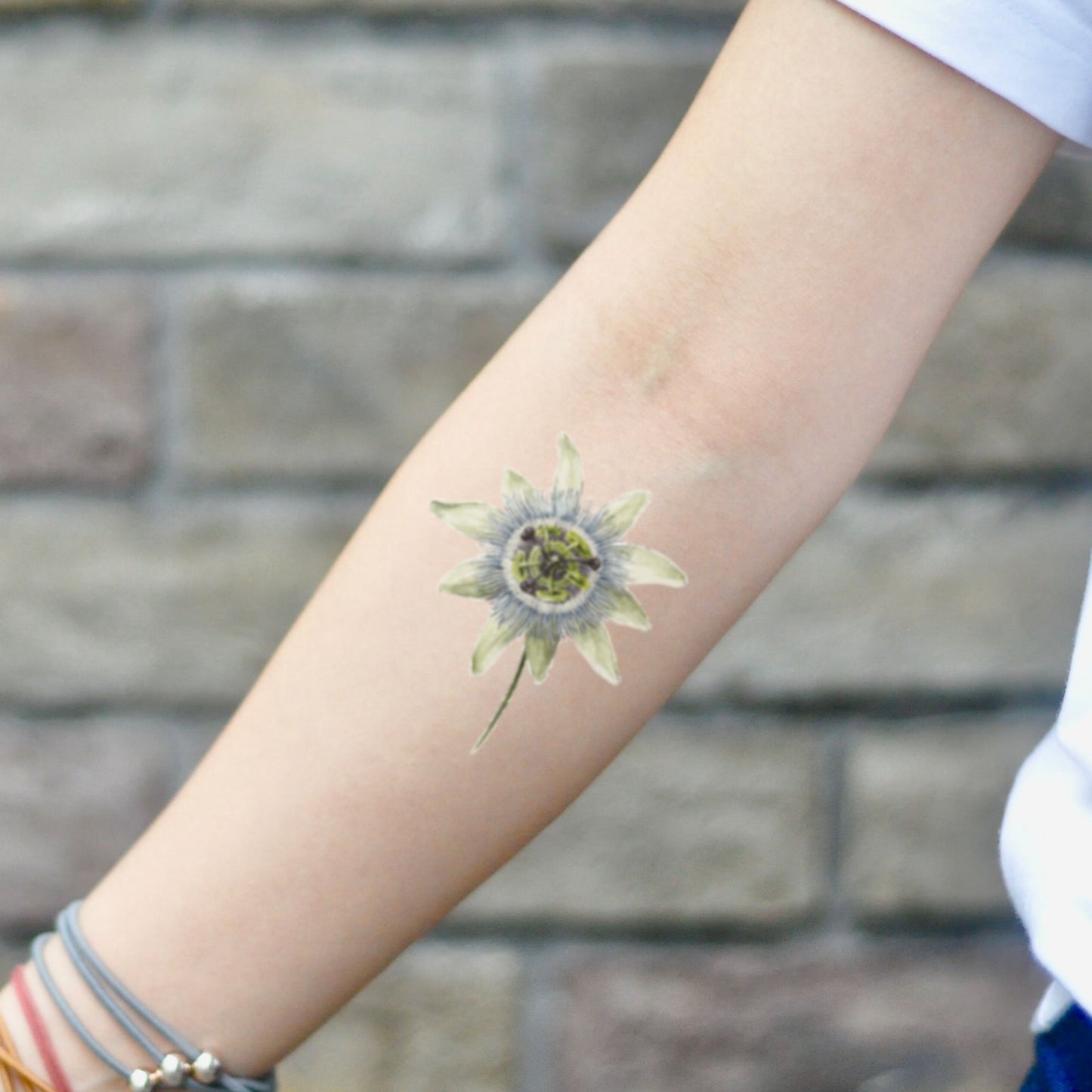 fake small passion flower flower temporary tattoo sticker design idea on inner arm