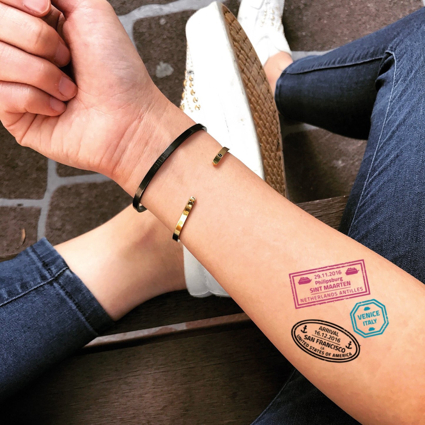 fake small passport stamp color temporary tattoo sticker design idea on forearm