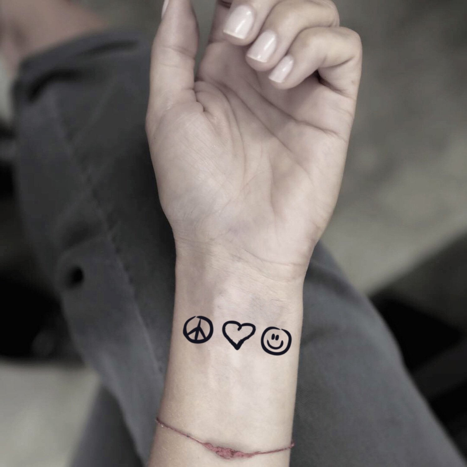 fake small peace love and happiness plur minimalist temporary tattoo sticker design idea on wrist