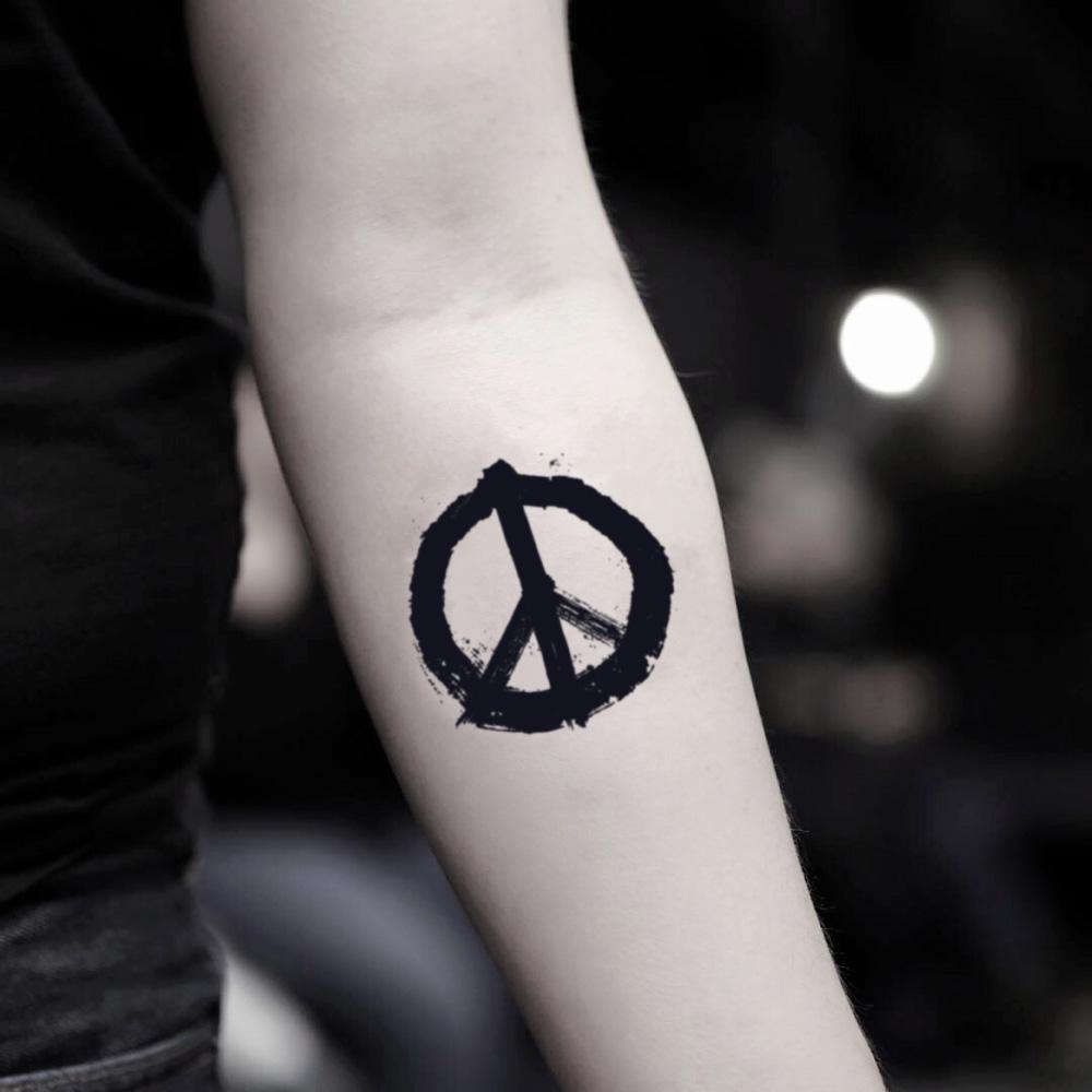 fake small peace symbol sign minimalist temporary tattoo sticker design idea on inner arm