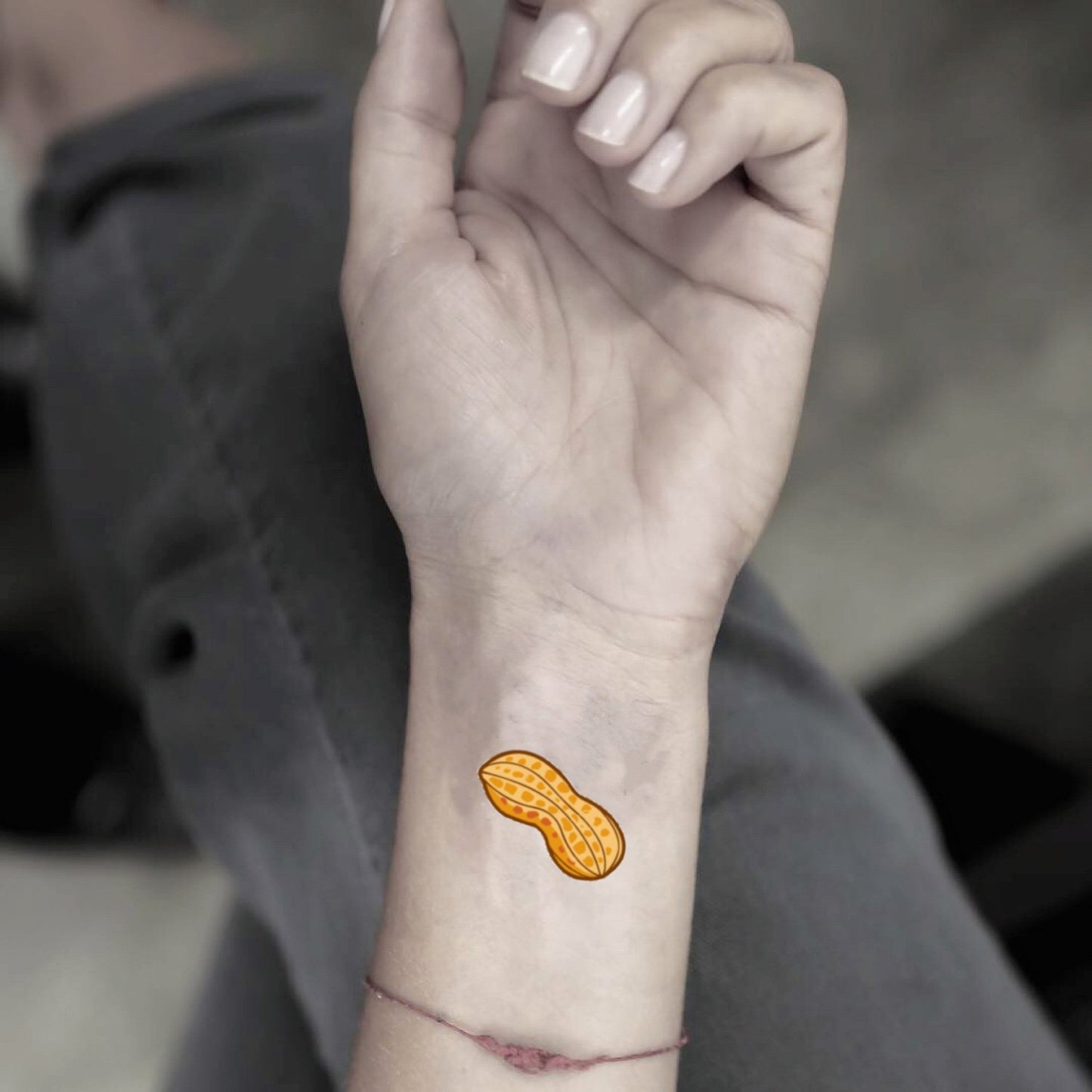 fake small peanut food temporary tattoo sticker design idea on wrist