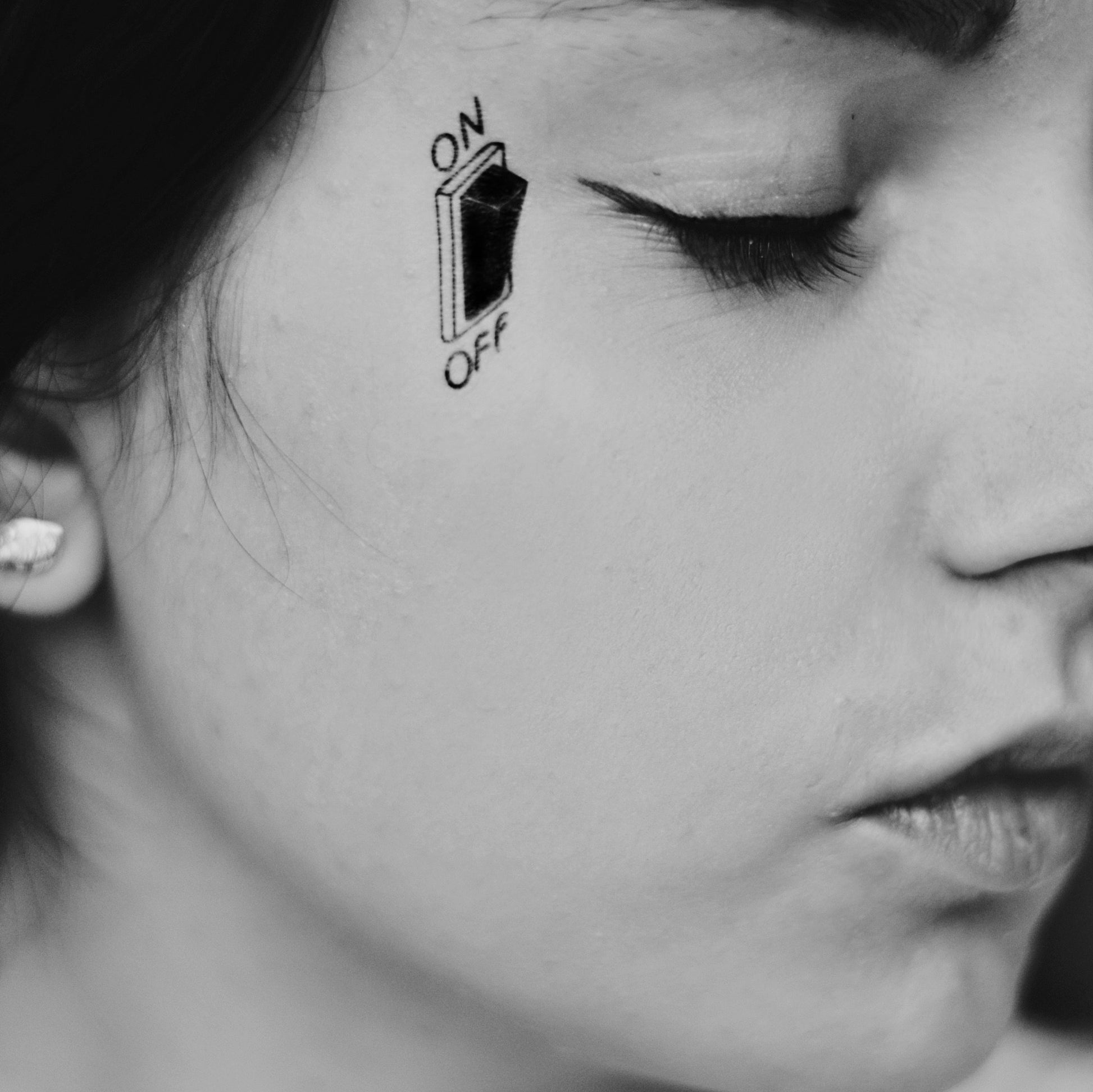 fake small power switch girl face minimalist temporary tattoo sticker design idea on face