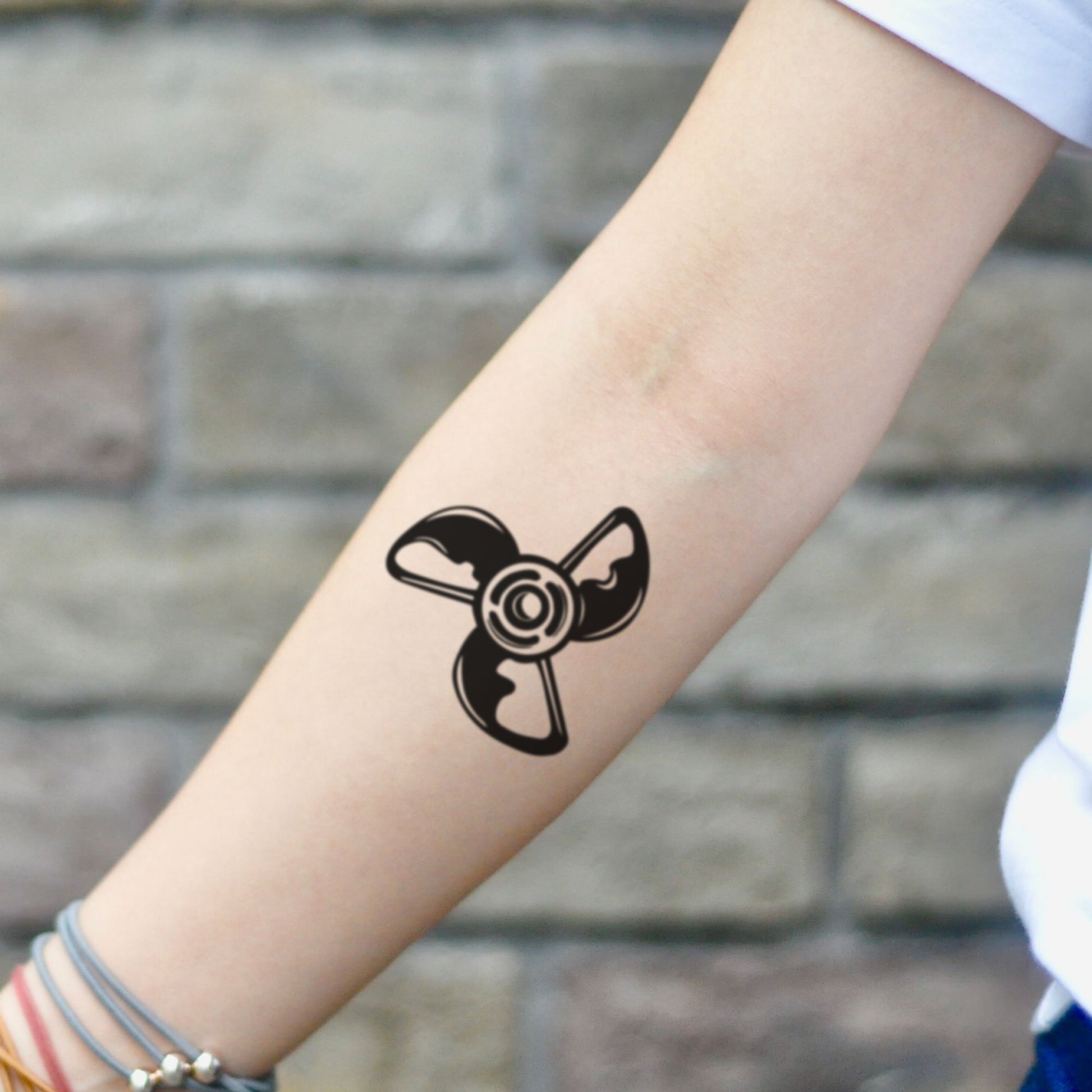 fake small propeller minimalist temporary tattoo sticker design idea on inner arm