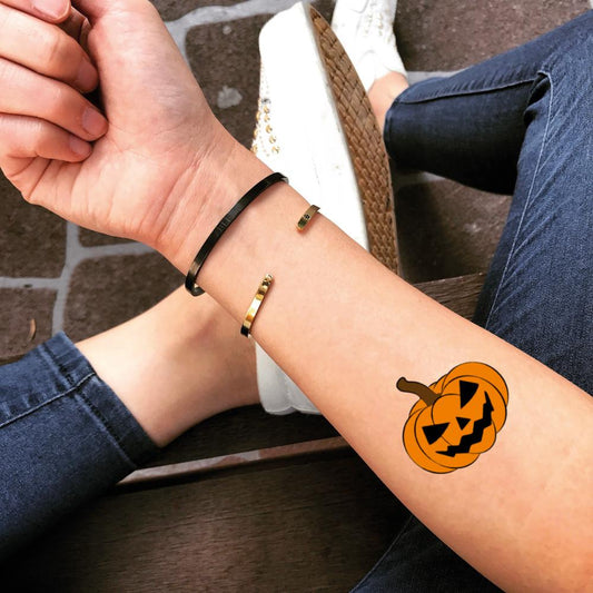 fake small pumpkin jack o lantern halloween color temporary tattoo sticker design idea on forearm