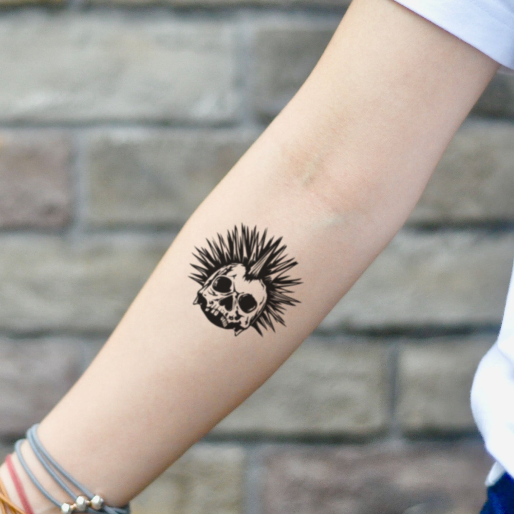 fake small punky punk rock skull pop old school stree rocker illustrative temporary tattoo sticker design idea on inner arm