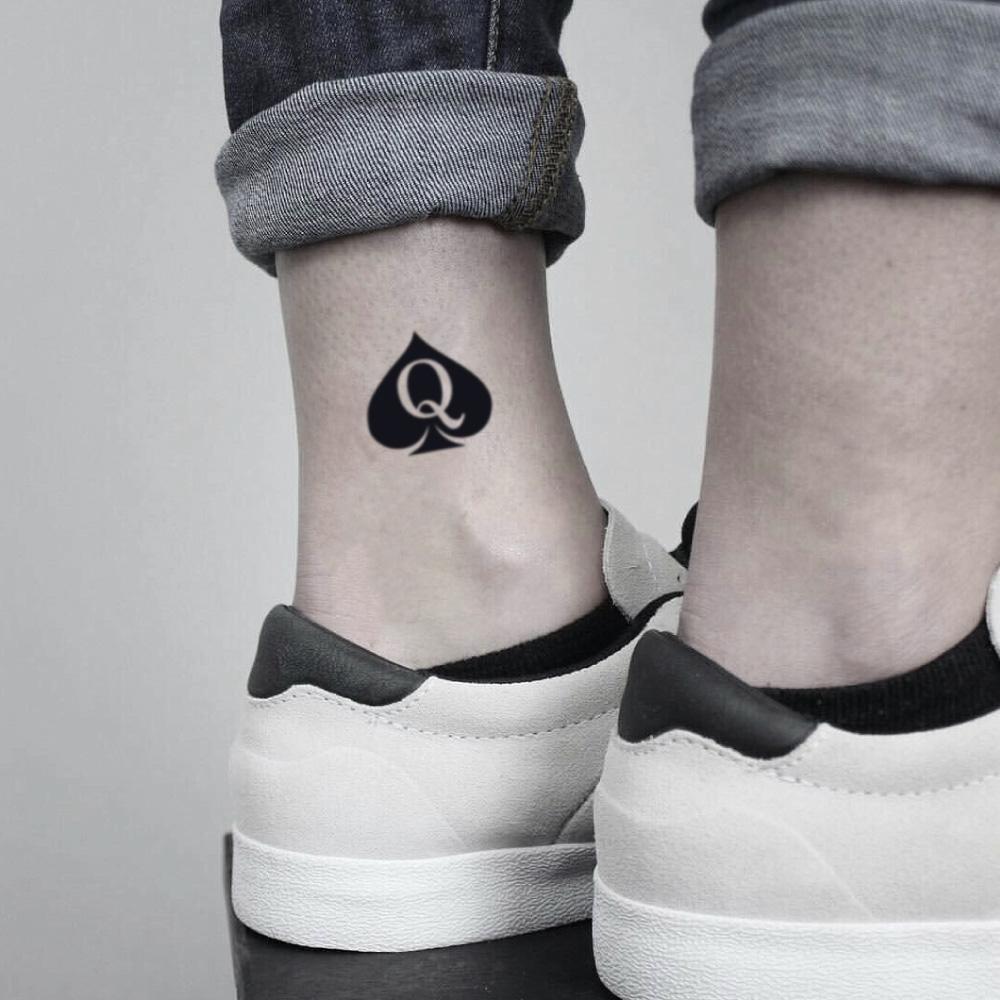 fake small queen of spades minimalist temporary tattoo sticker design idea on ankle