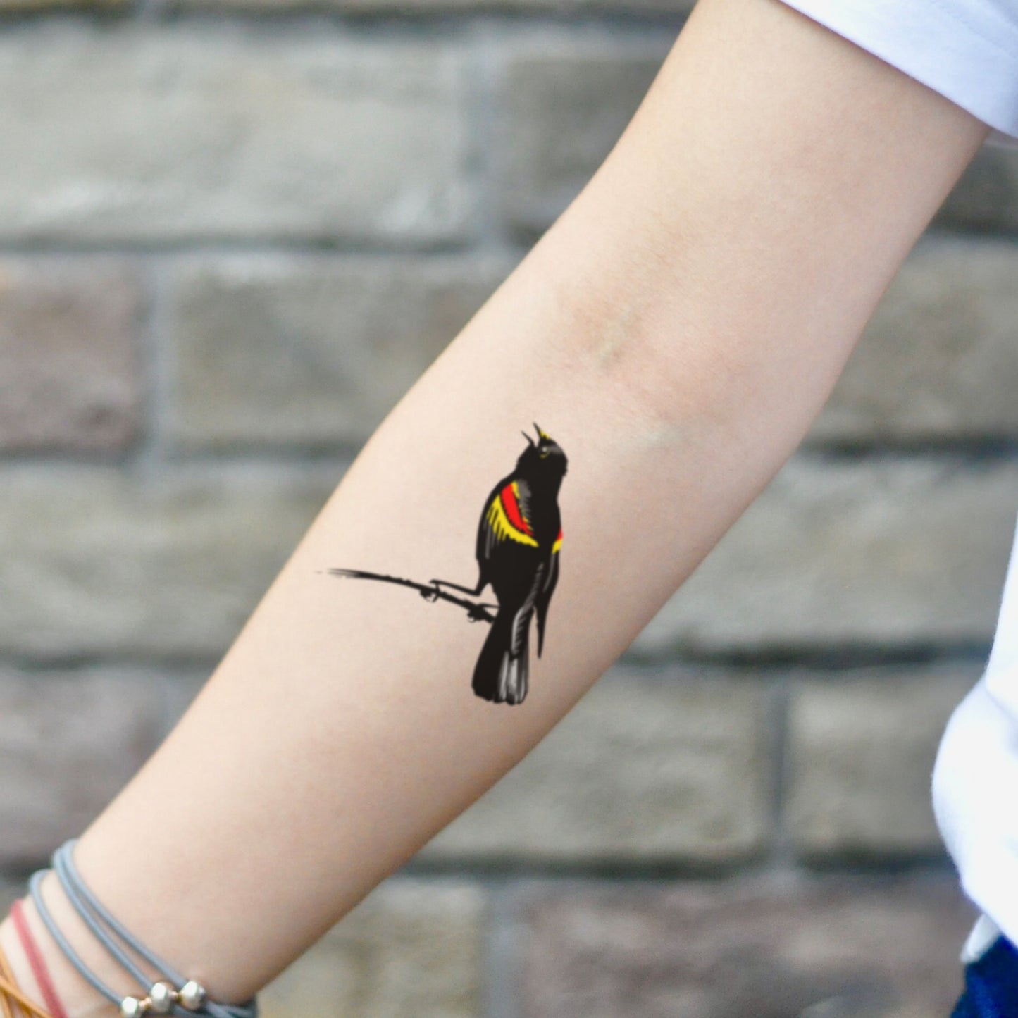 fake small red winged blackbird animal temporary tattoo sticker design idea on inner arm
