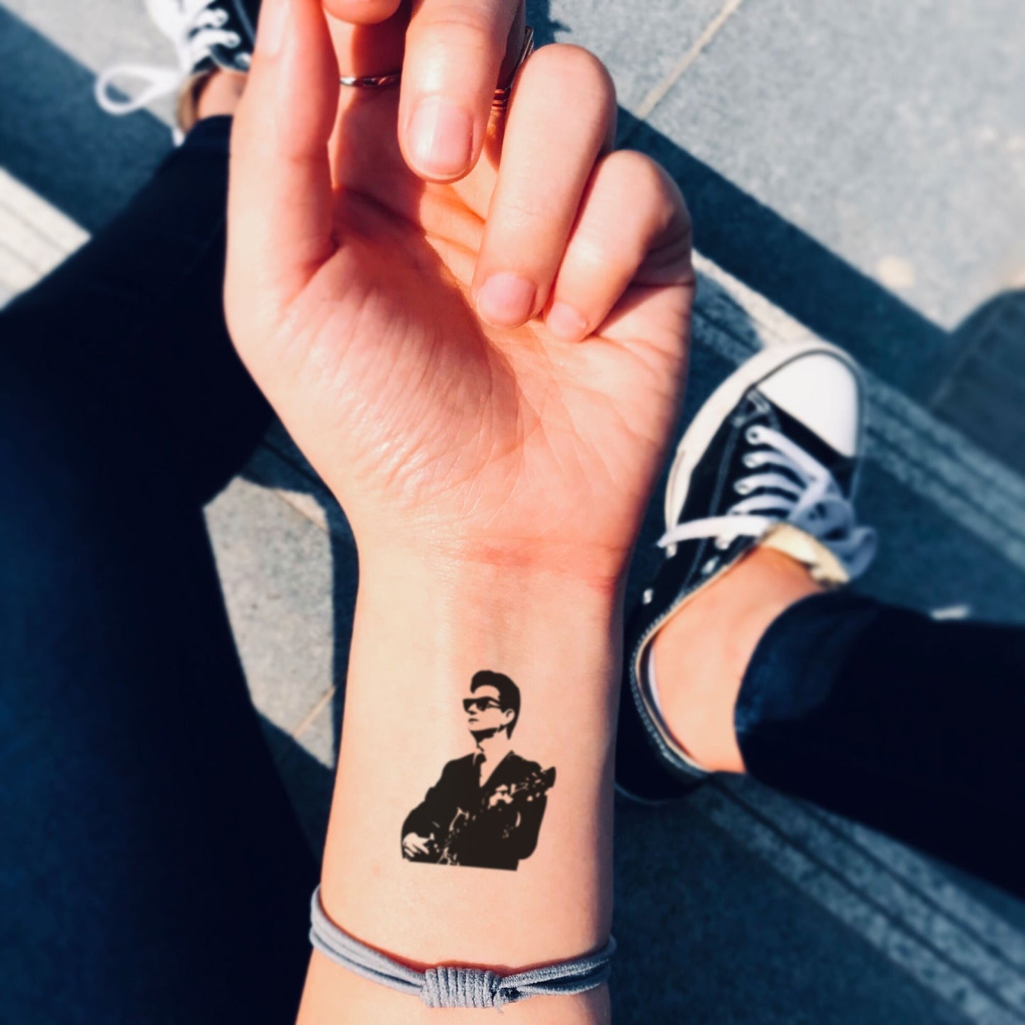 fake small roy orbison portrait temporary tattoo sticker design idea on wrist