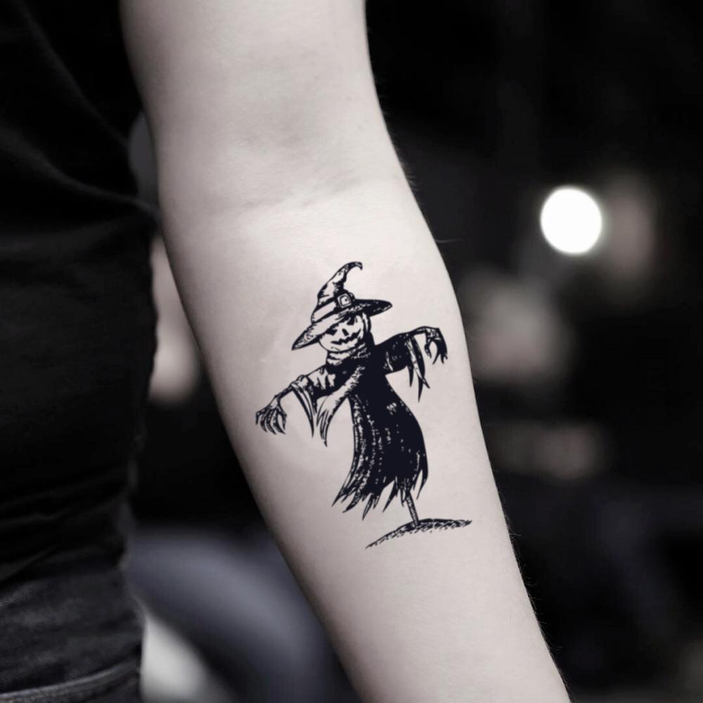 fake small scarecrow illustrative temporary tattoo sticker design idea on inner arm