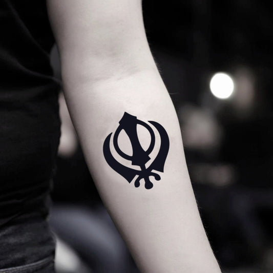 fake small khanda sikh symbol illustrative temporary tattoo sticker design idea on inner arm
