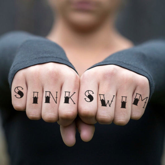 fake small sink or swim old school script lettering temporary tattoo sticker design idea on finger