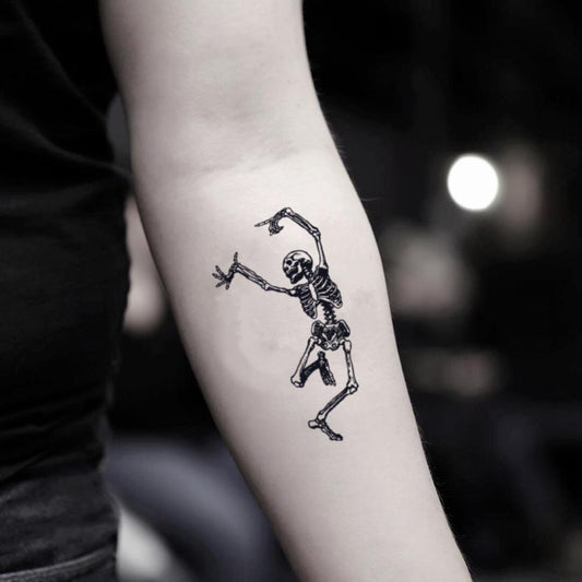 fake small skeleton skull dance macabre illustrative temporary tattoo sticker design idea on inner arm