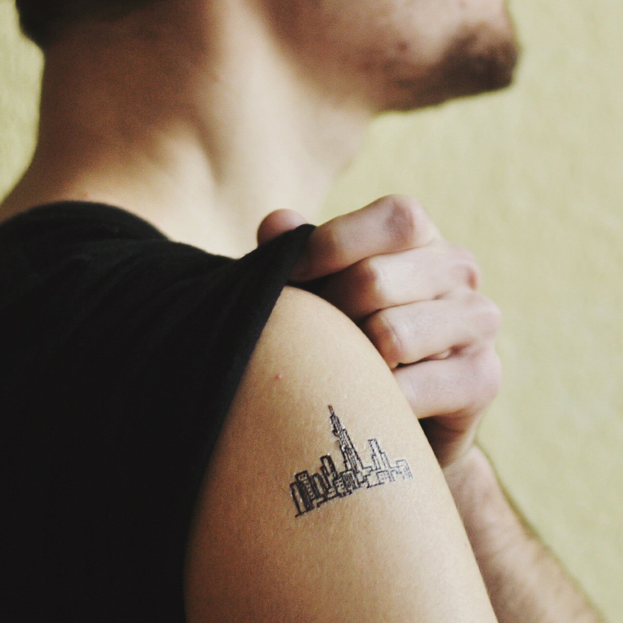 fake small skyline cityscape manhattan minimalist temporary tattoo sticker design idea on upper arm