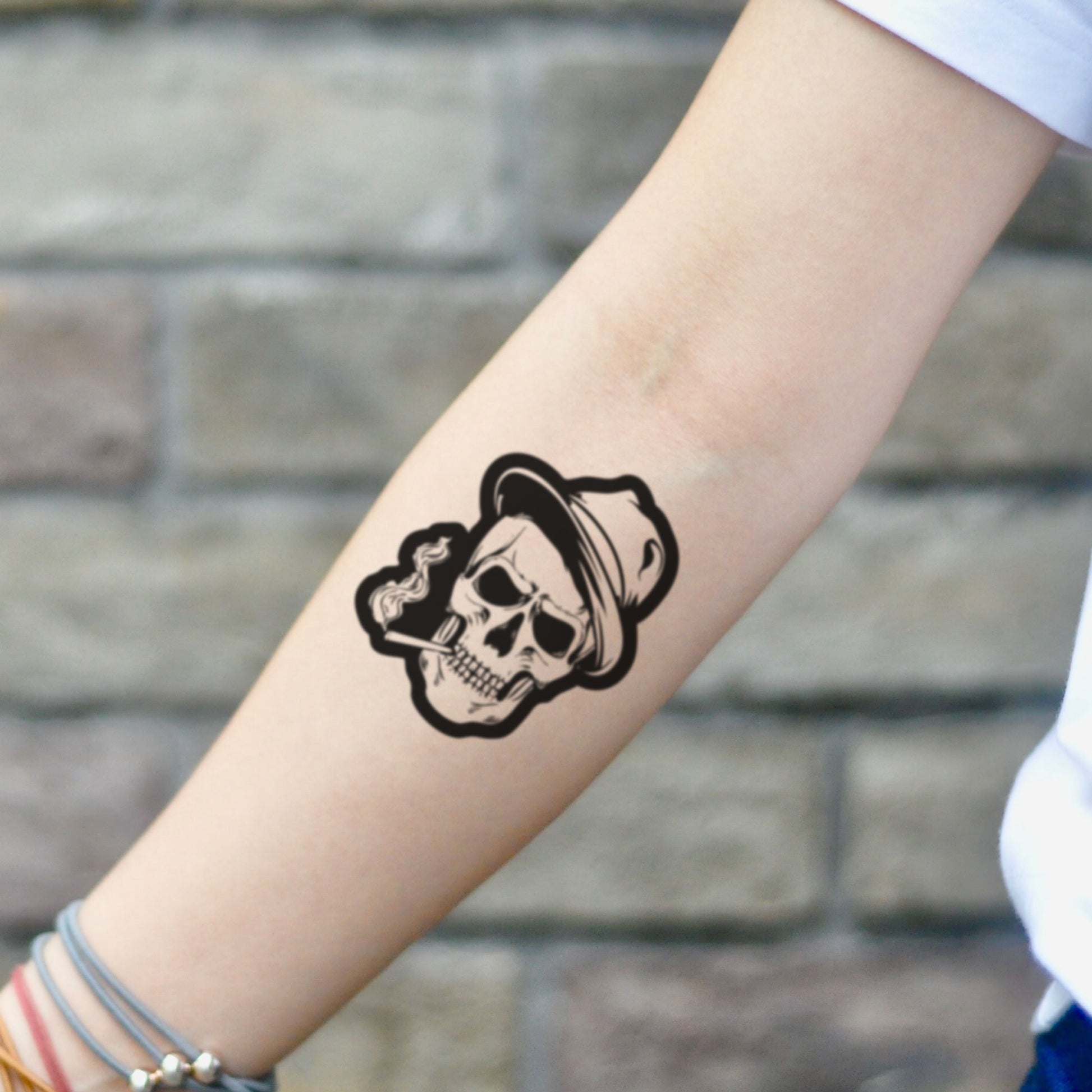 fake small smoking skull head smokey cigarette illustrative temporary tattoo sticker design idea on inner arm
