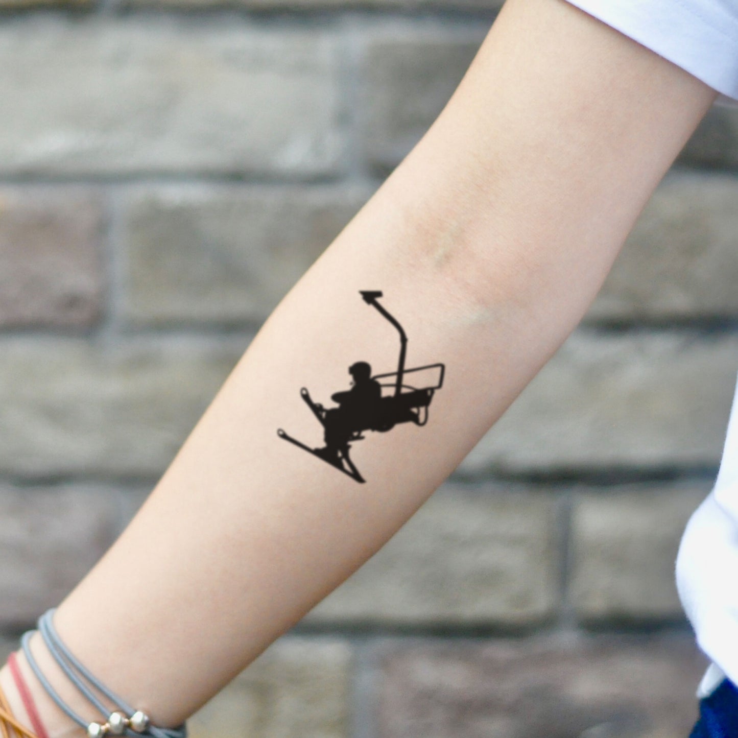 fake small snowboard ski illustrative temporary tattoo sticker design idea on inner arm