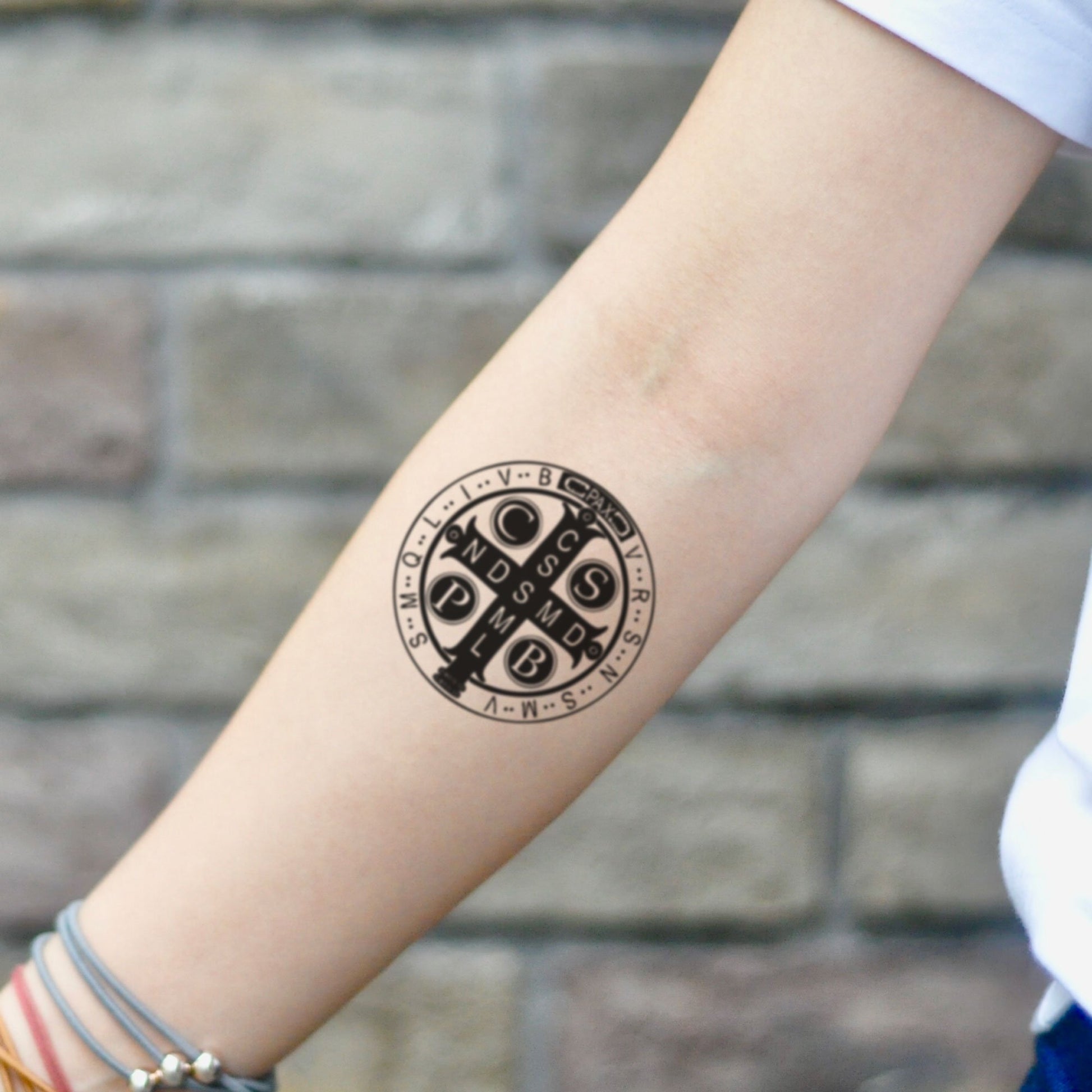 fake small st benedict medal catholic cross symbol illustrative temporary tattoo sticker design idea on inner arm