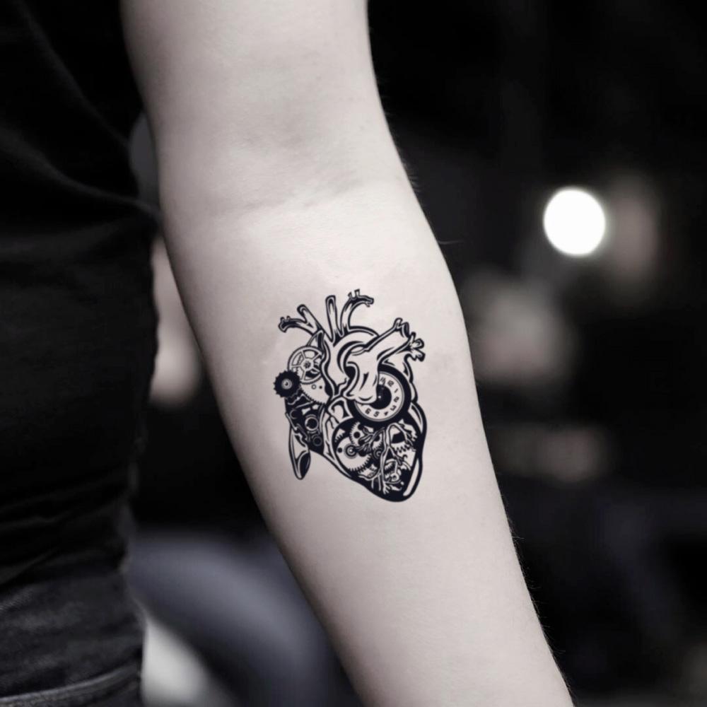 fake small steampunk mechanical heart illustrative temporary tattoo sticker design idea on inner arm