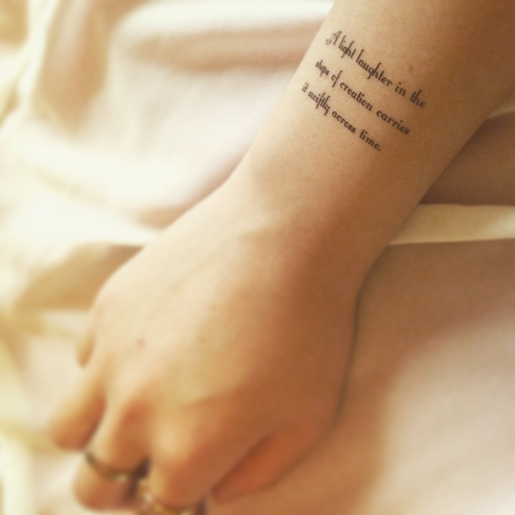 fake small tagore poems lettering temporary tattoo sticker design idea on wrist