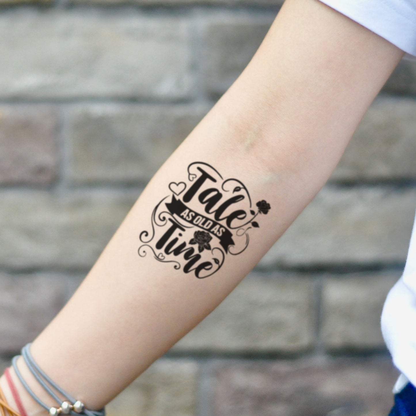 fake small tale as old as time lettering temporary tattoo sticker design idea on inner arm