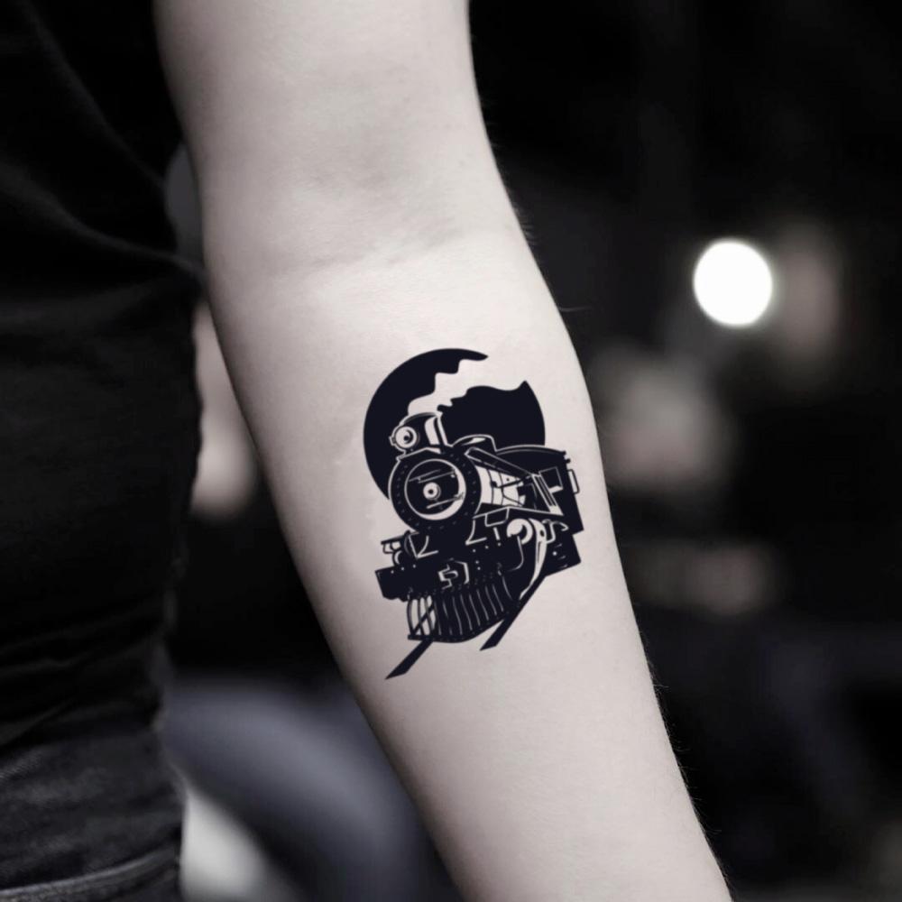 fake small train locomotive illustrative temporary tattoo sticker design idea on inner arm