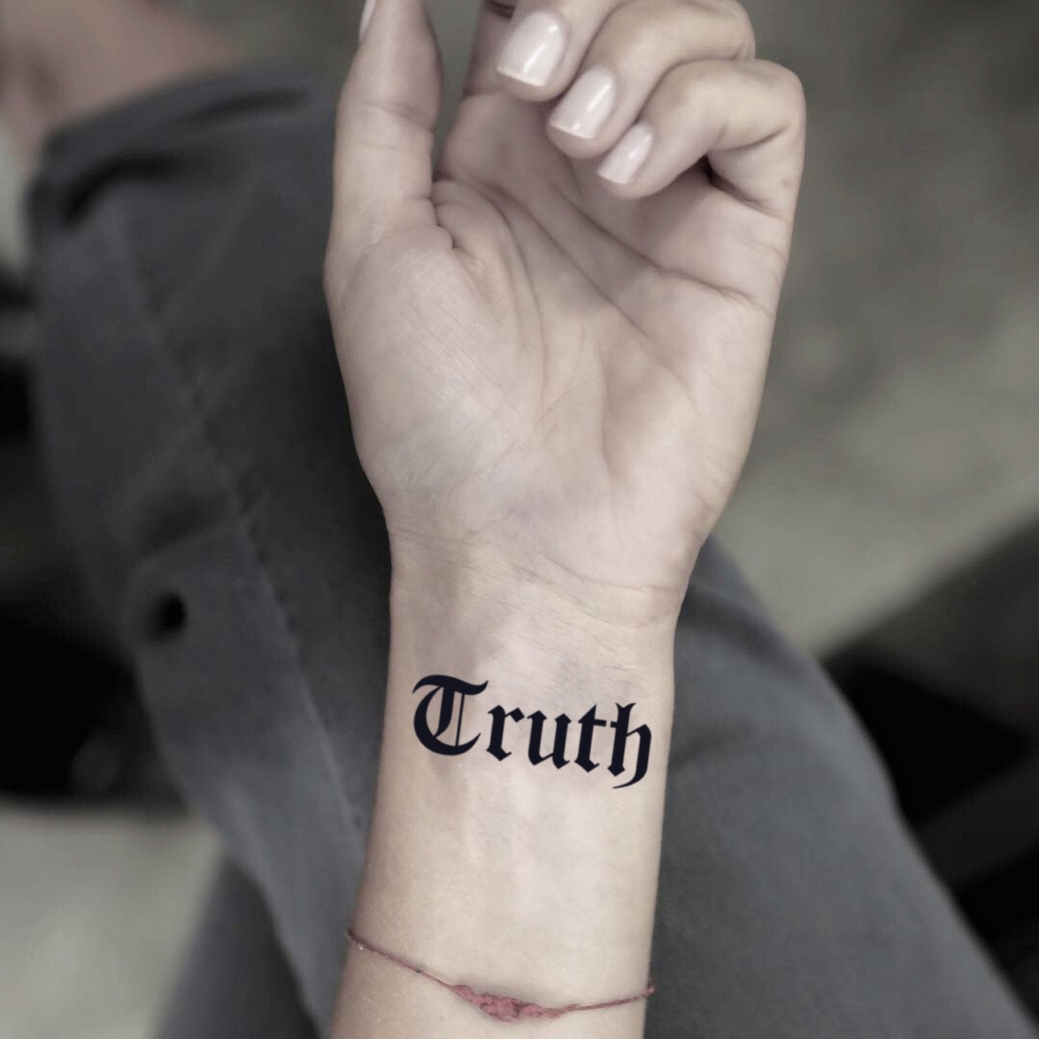 fake small truth gothic font lettering temporary tattoo sticker design idea on wrist