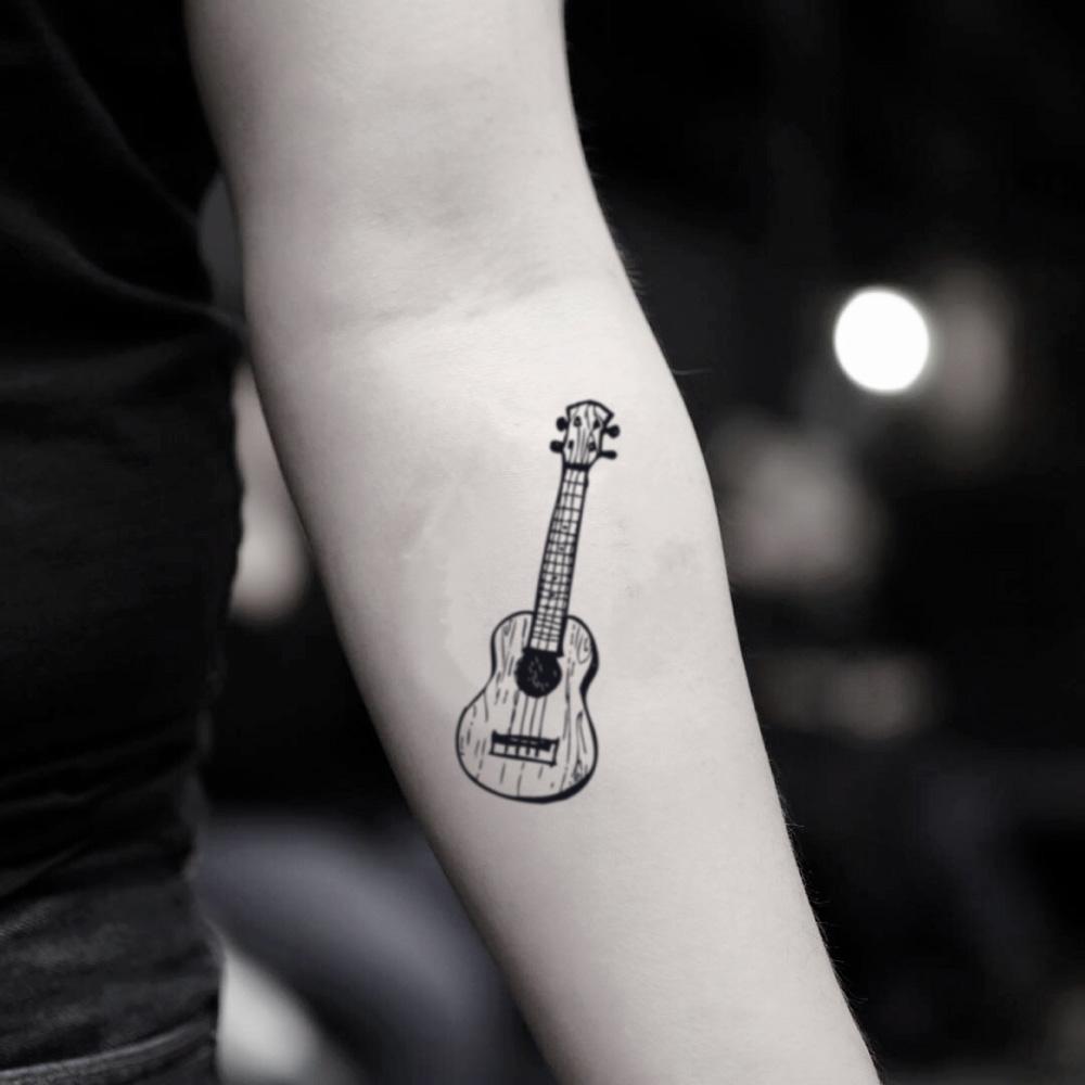 fake small ukulele music temporary tattoo sticker design idea on inner arm