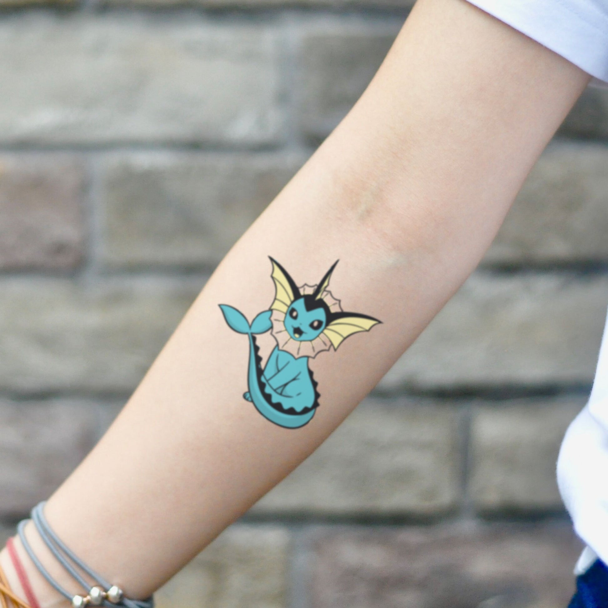 fake small vaporeon pokemon cartoon temporary tattoo sticker design idea on inner arm