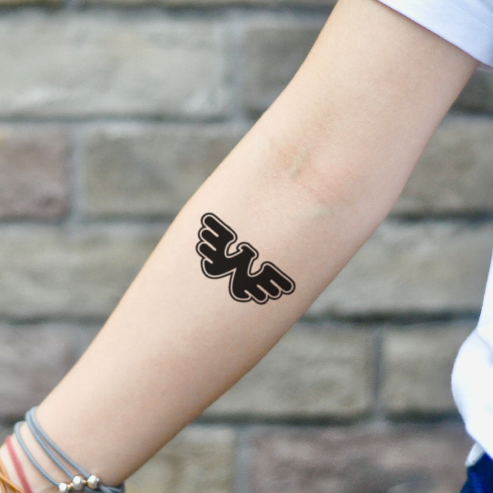 fake small waylon jennings flying w symbol logo minimalist temporary tattoo sticker design idea on inner arm