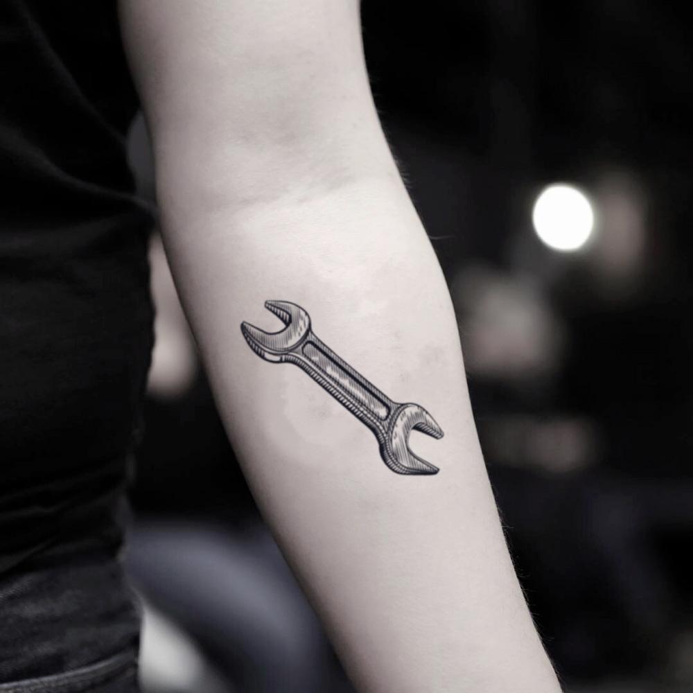 fake small pipe wrench ratchet illustrative temporary tattoo sticker design idea on inner arm